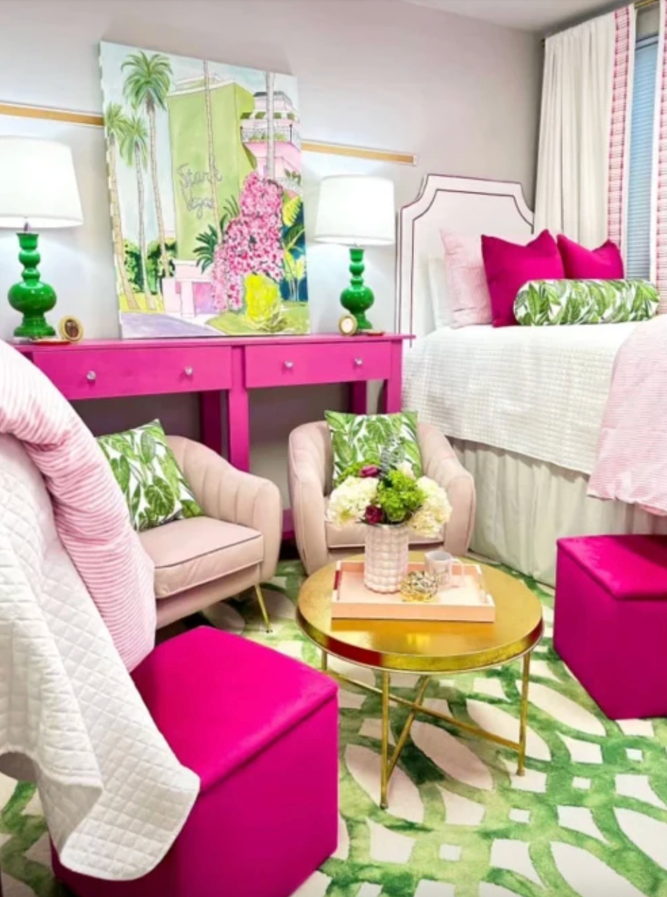 Dorm room that is excessively styled with vibrant pink, green, and white decor.