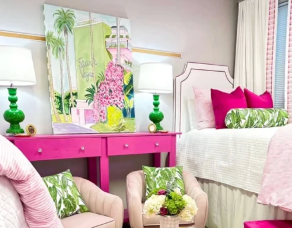 Dorm room that is excessively styled with vibrant pink, green, and white decor.