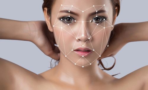 Close-up of woman's face with computer grid lines superimposed.