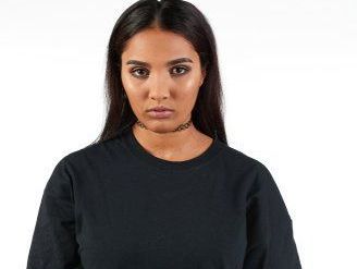 Young woman wearing oversized shirt.
