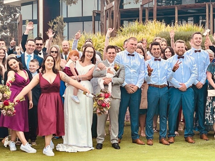 A Large Group of People Are Posing for A Picture at A Wedding