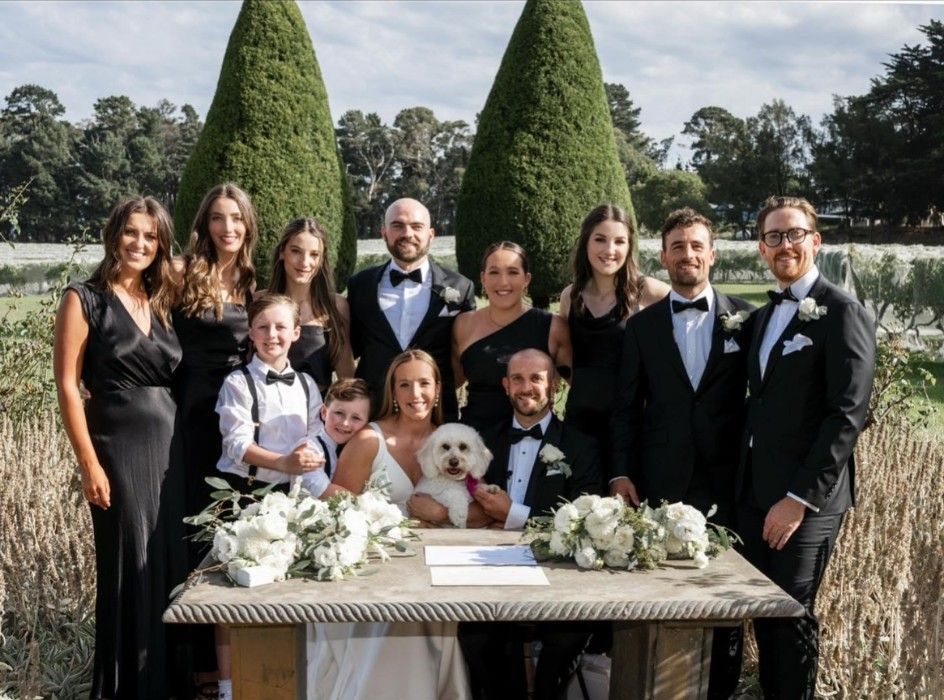 A Group of People Standing Around a Table with A Dog on It