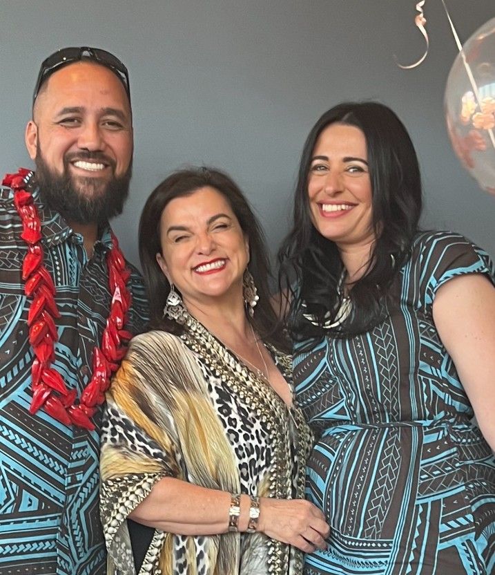 A Man and Two Women Are Posing for A Picture Together