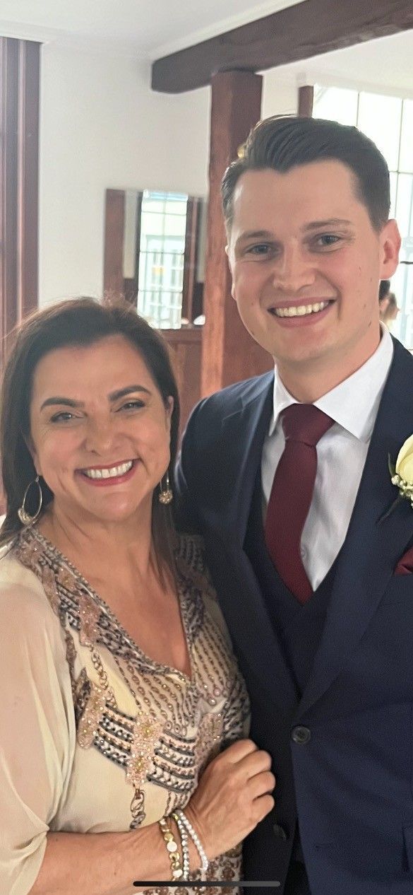 A Man in A Suit and Tie Is Standing Next to A Woman in A Dress