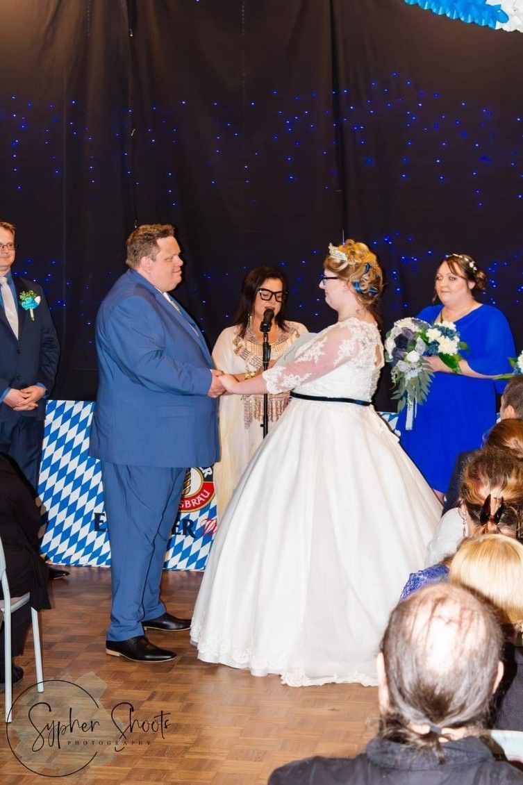 A bride and Groom Are Holding Hands During Their Wedding Ceremony