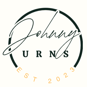 Logo for Johnny Urns: Black and white script "Johnny" over black circle, "URNS" below. "EST 2023" in gold.