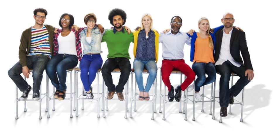 Group of diverse people sitting together, arm in arm. They are on stools, wearing various colorful outfits. White background.