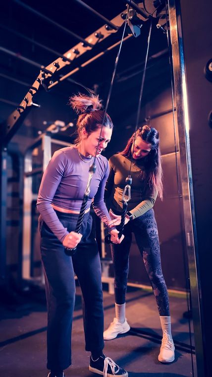 Female personal trainer guiding a beginner workout at Mahila gym Brampton