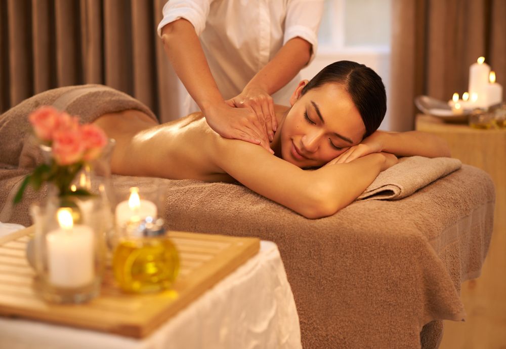 A beautiful young woman enjoying a massage at the spa.