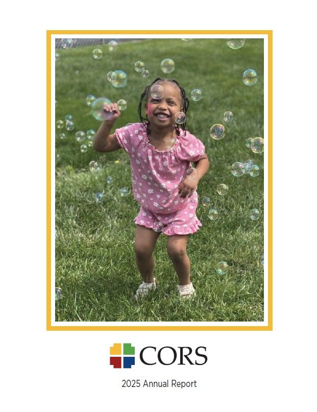 Little girl smiling with bubbles all around her. 