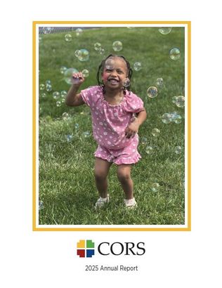 Little girl smiling with bubbles all around her. 