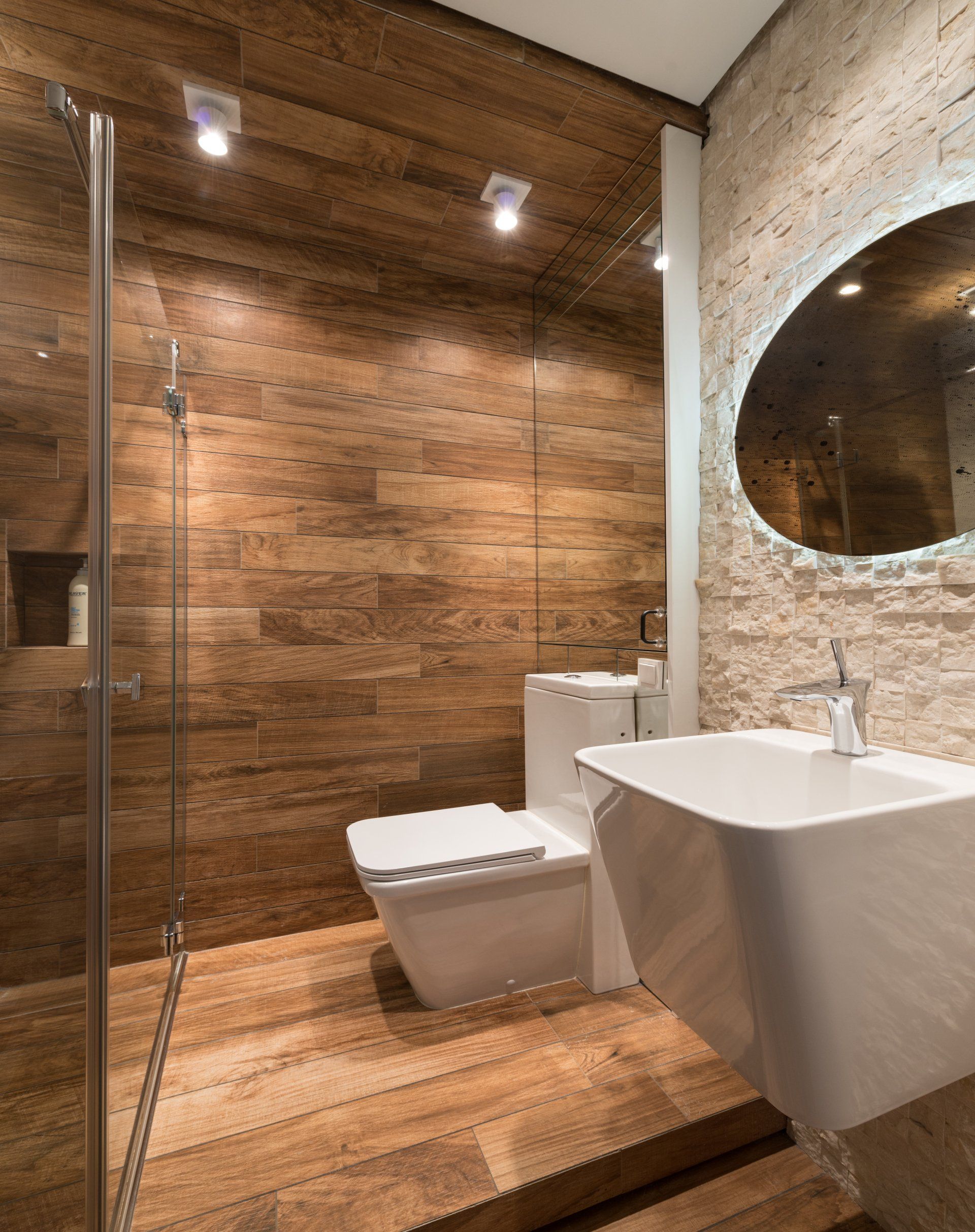 Bathroom makeover using natural wood tones and cream stone walls