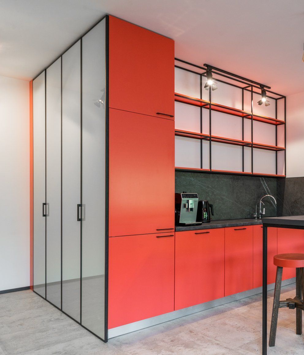 a red kitchen with red cabinets and white shelves: Top Kitchen Trends to Embrace in 2024