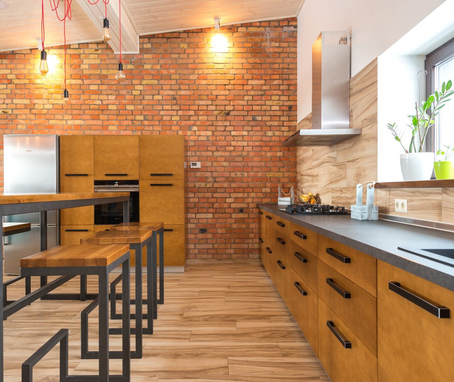 a remodeled kitchen with wooden cabinets and a brick wall  - Secrets of Kitchen Renovation Costs