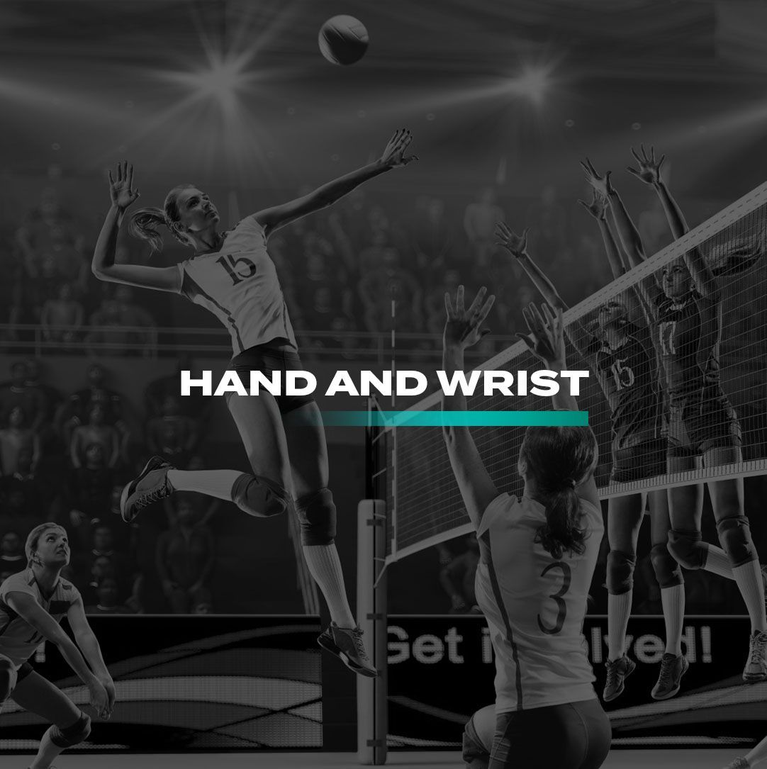 A woman is jumping in the air to catch a volleyball while playing volleyball with the word Hand and wrist in front of her.
