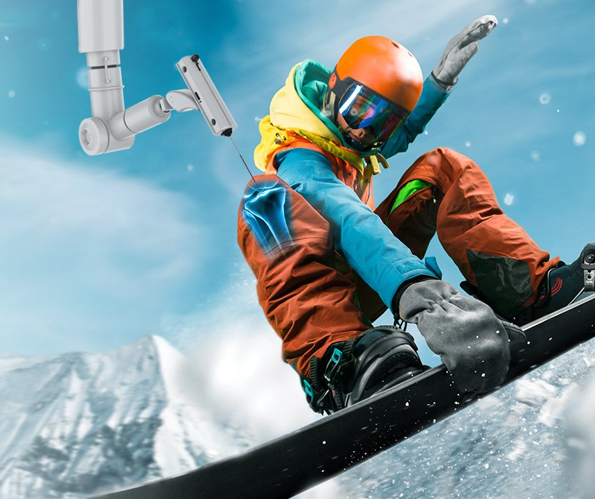 A snowboarder is doing a trick in the air while wearing a helmet and goggles.