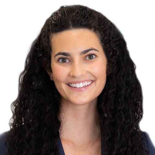 A woman with curly hair is smiling for the camera.