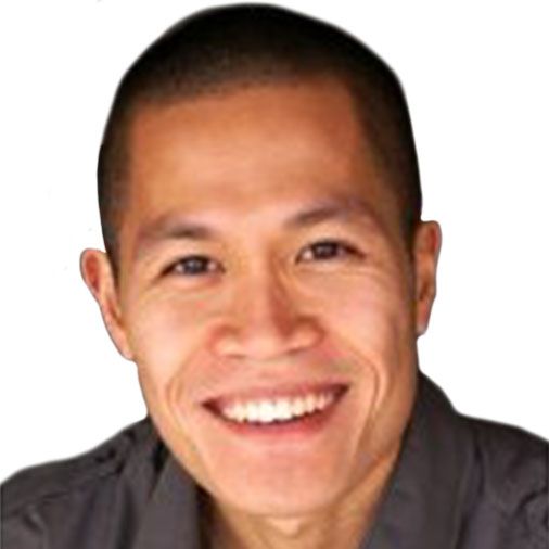 A man with a shaved head is smiling for the camera.