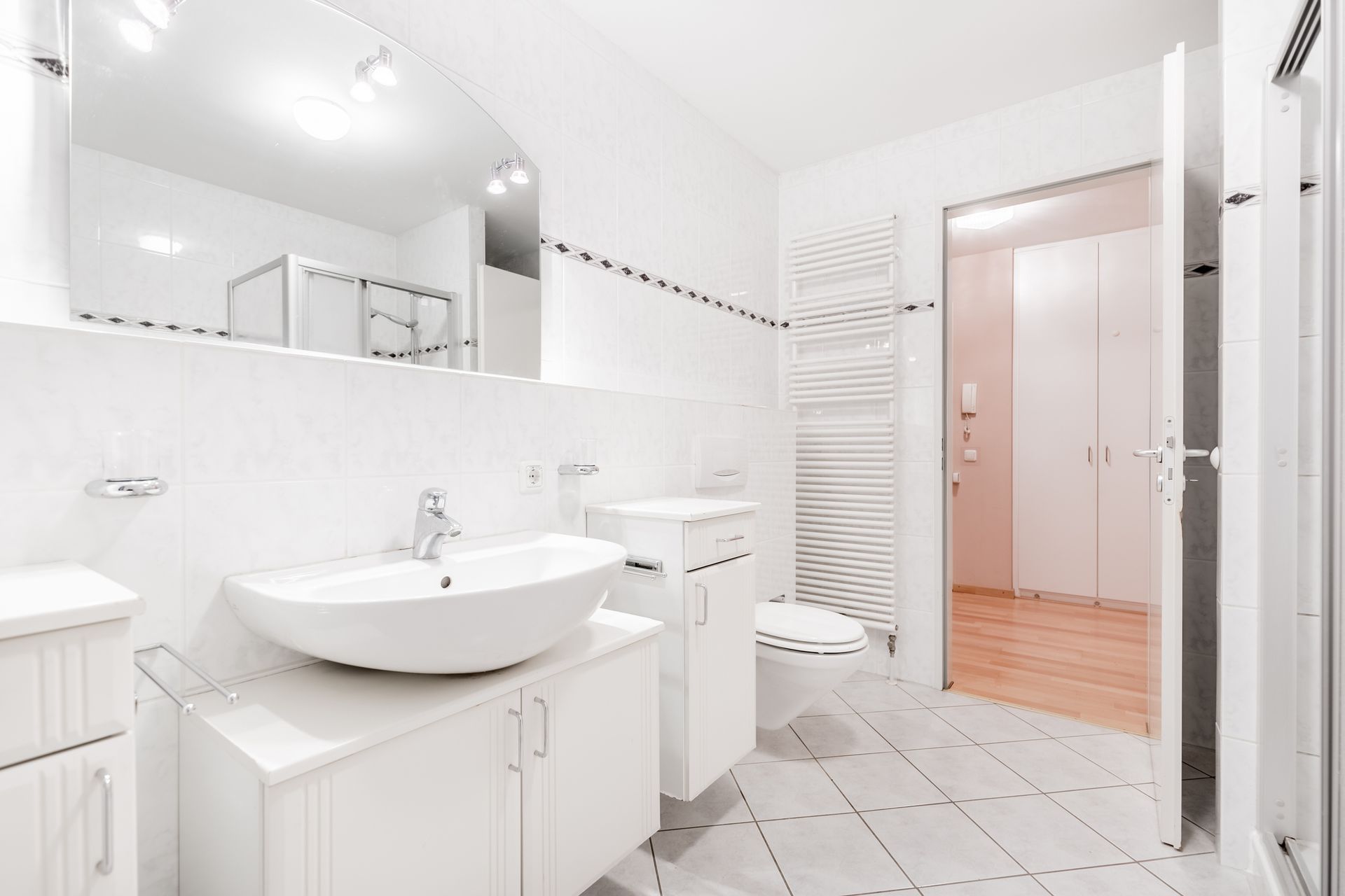 A bathroom with a sink , toilet , and mirror.