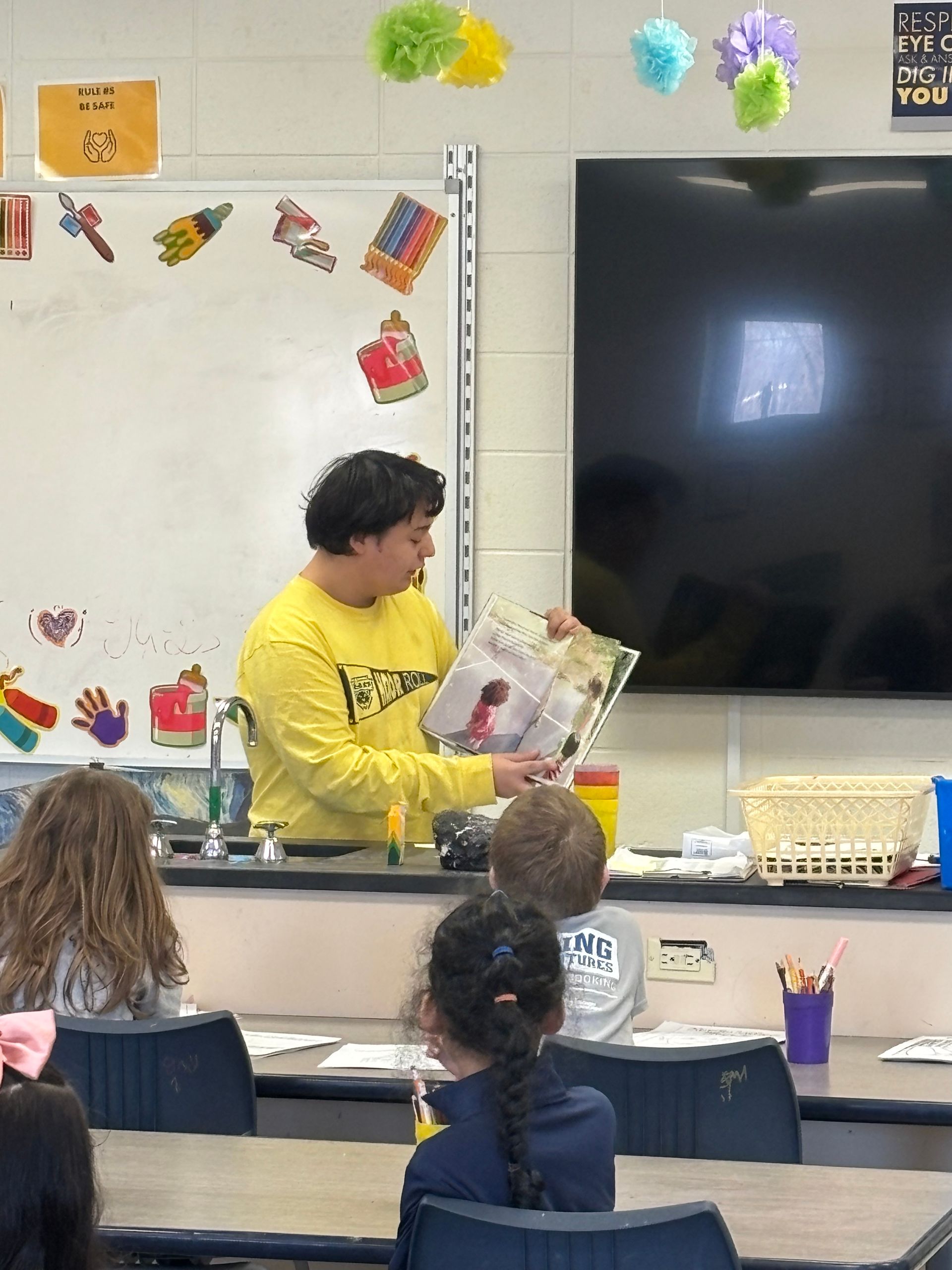 Student Council reading books about kindness and friendship to elementary students