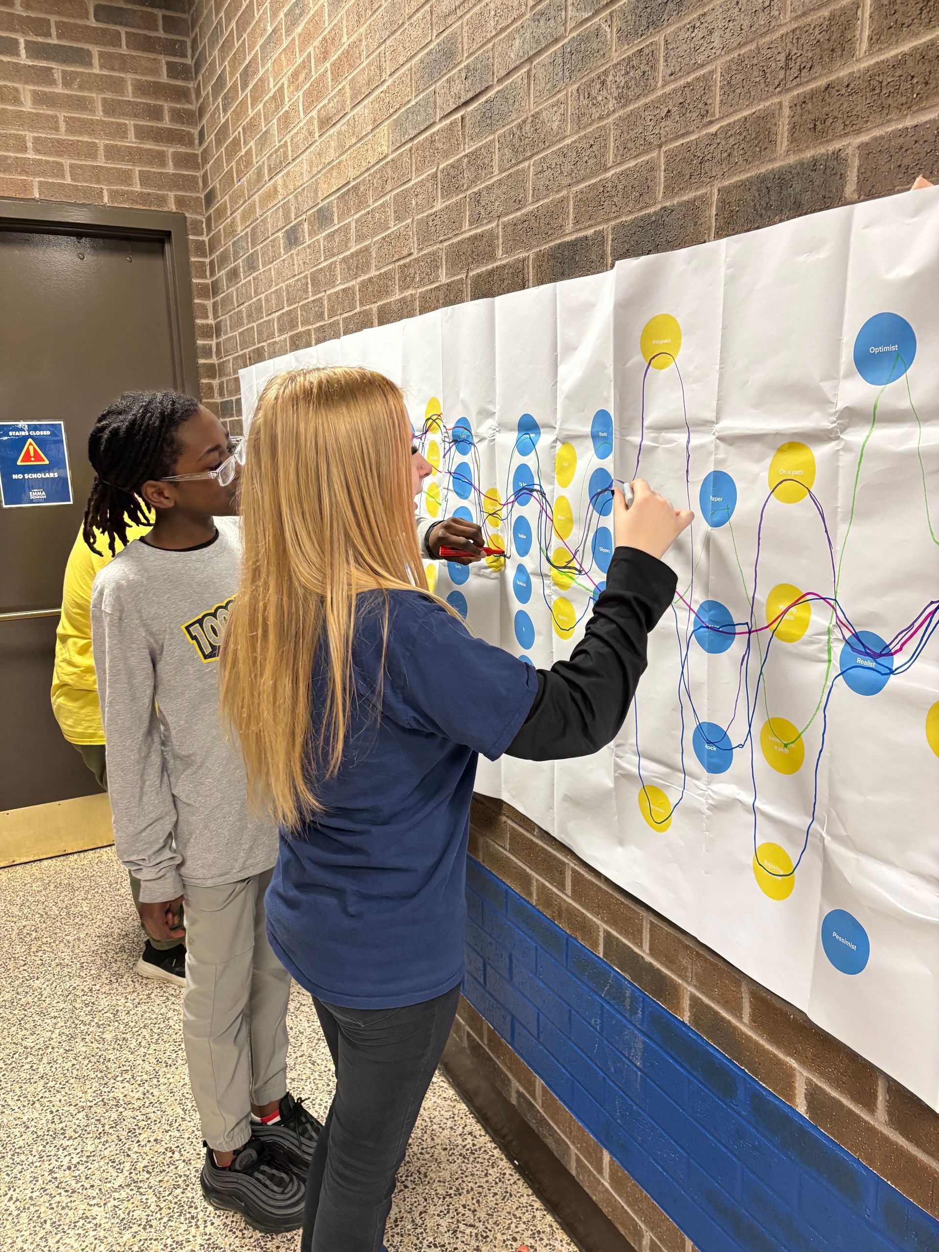 Middle school students participating in No One Eats Alone Day activity