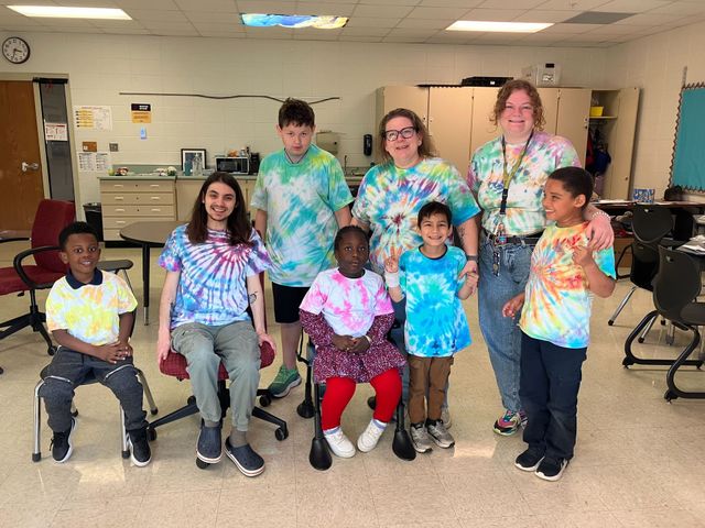 Students wearing tie-dye shirts from Spot Emotions lesson.