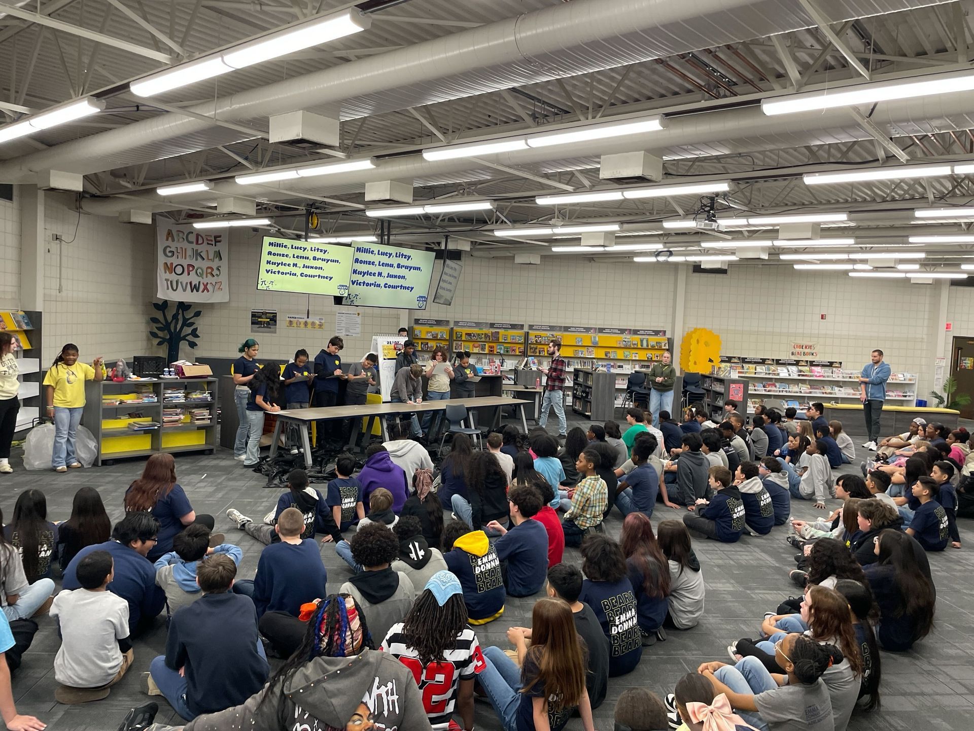 Middle school students celebrating Pi Day with a friendly competition and staff being pied in the face