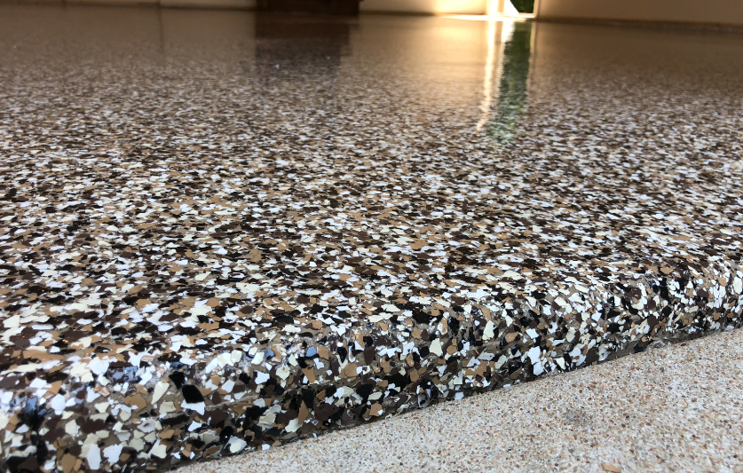 a patio with a concrete floor and epoxy flake .