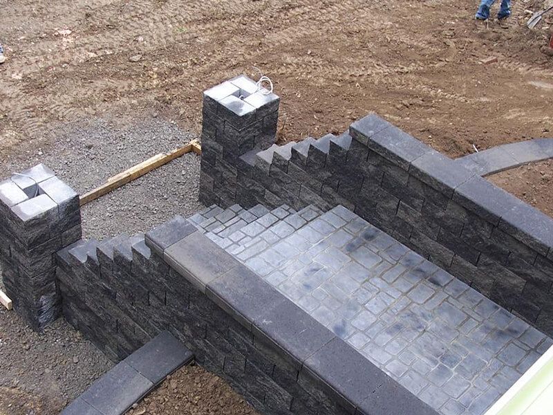A staircase made of bricks is being built in the dirt.