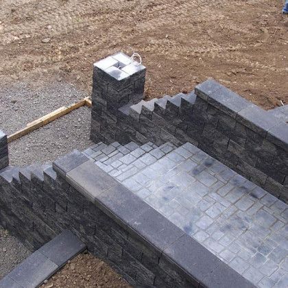 A brick wall with stairs going up to it