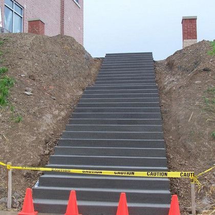 A group of men are working on a concrete floor.