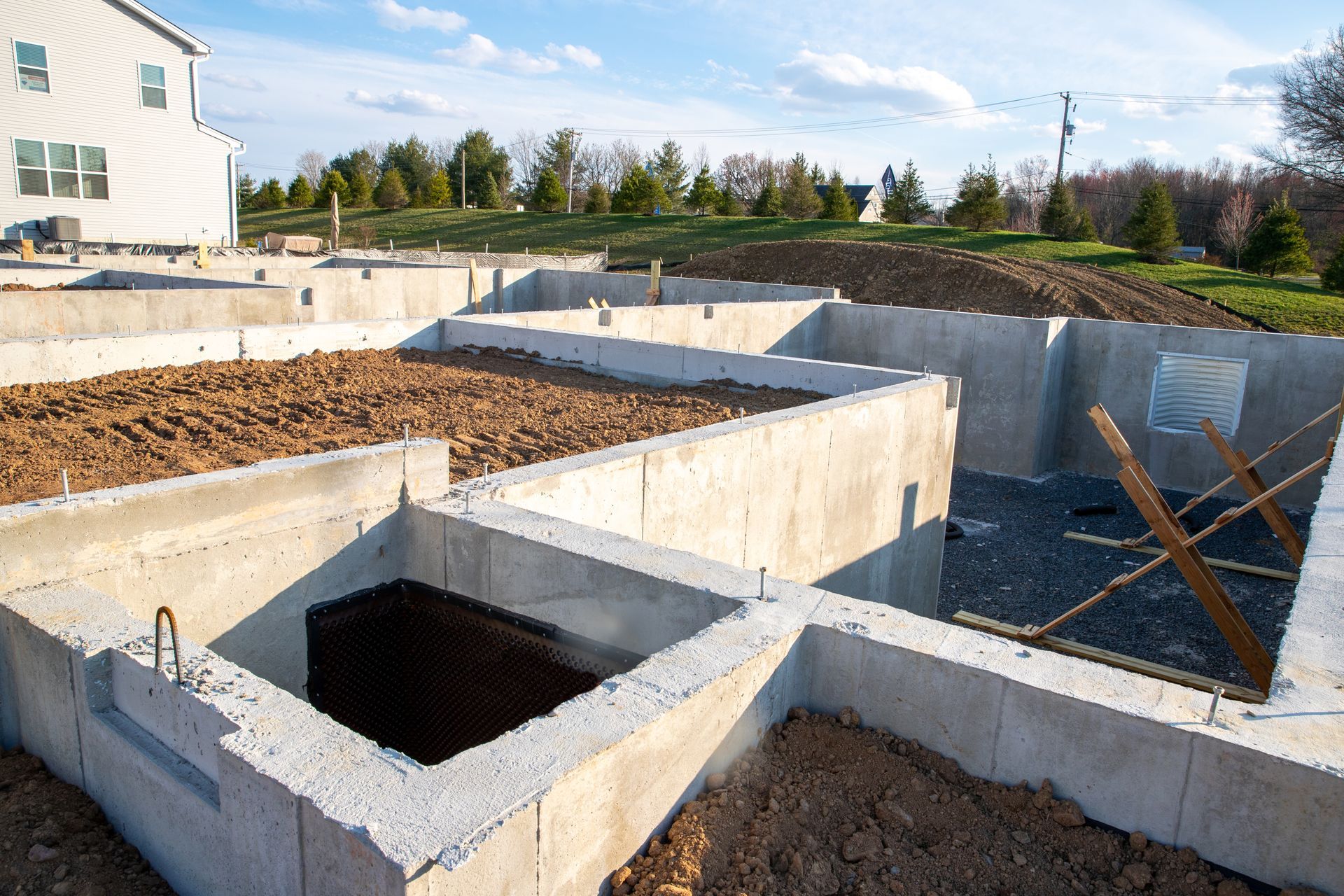 A concrete foundation for a house is being built.