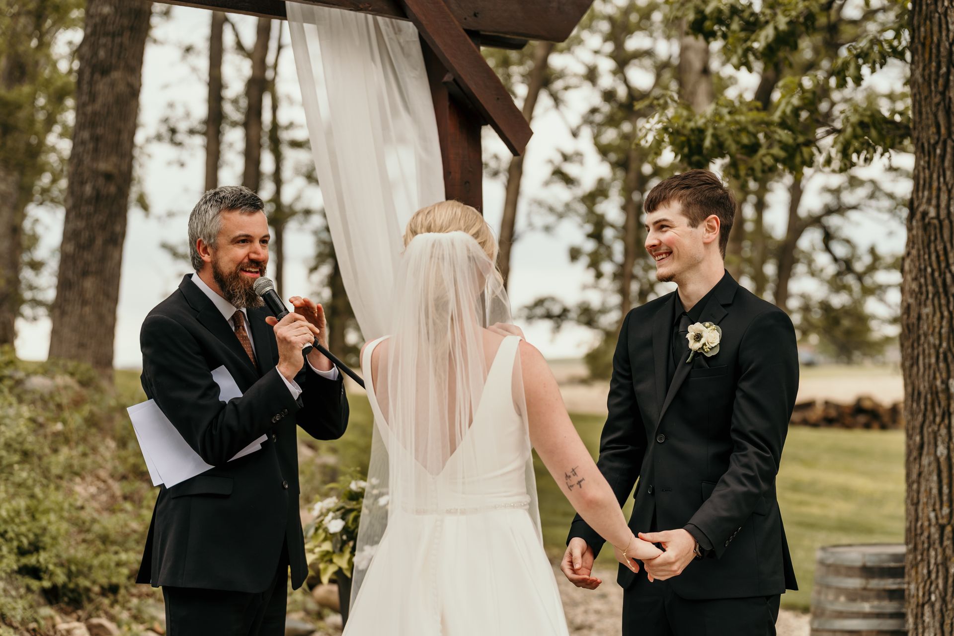 Bride and groom exchanging vows during their wedding ceremony in Joice, IA.