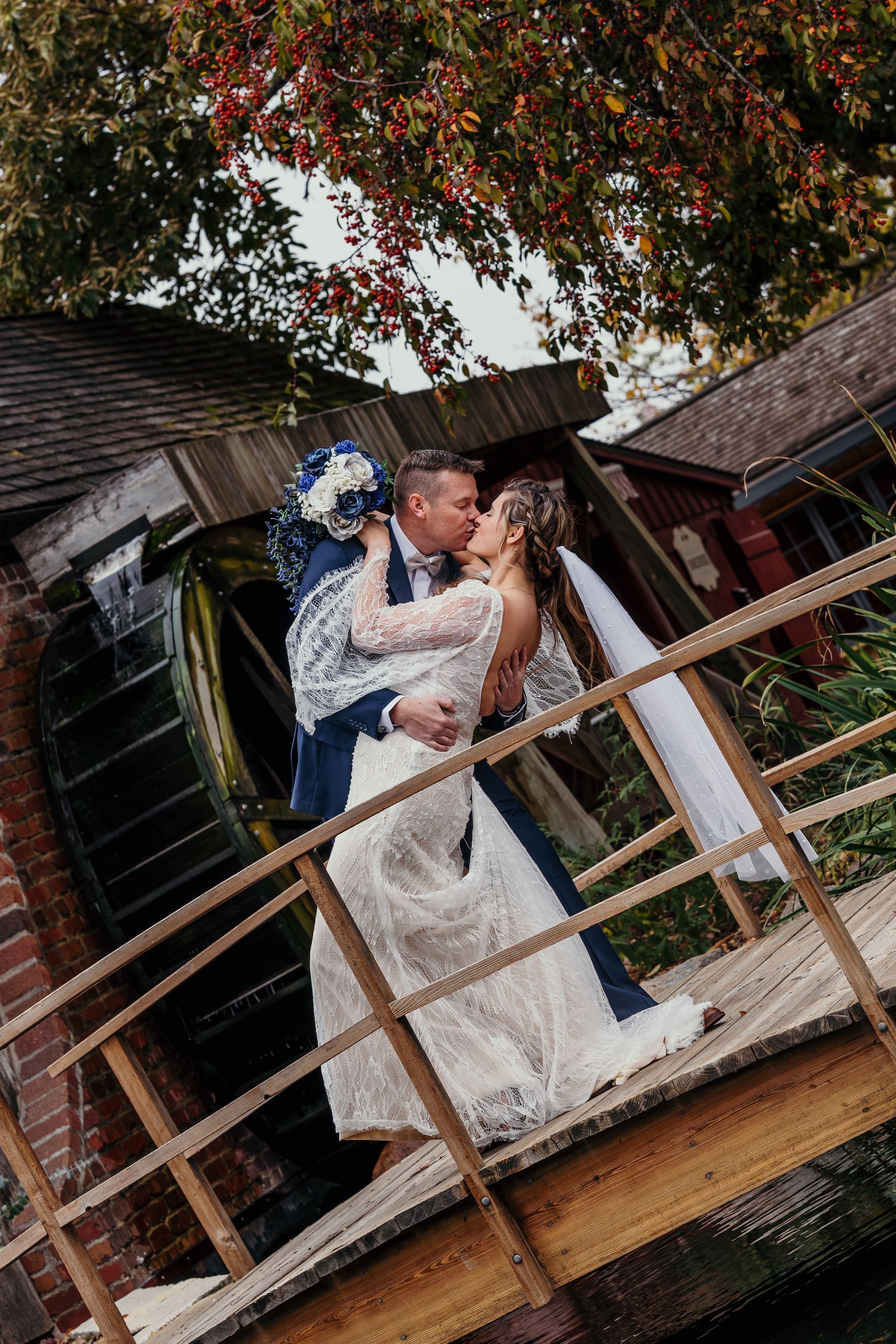 Wedding couple kissing on a bridge in Pella, IA on their wedding day.