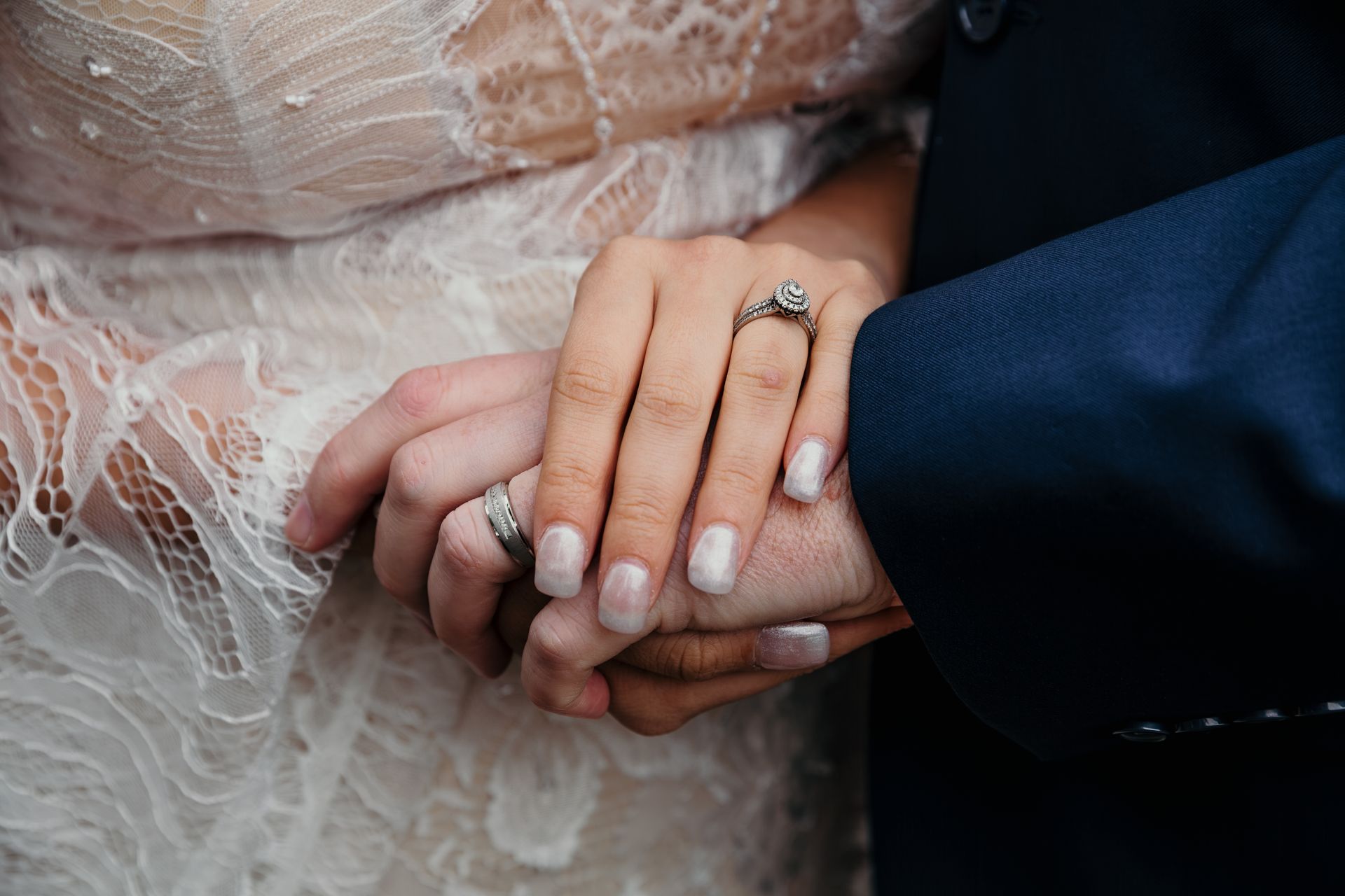 Bride and groom  displaying their wedding rings during a portrait session in Pella, IA.