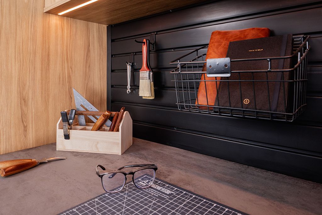 A room with a wooden wall and a cutting board on the floor.