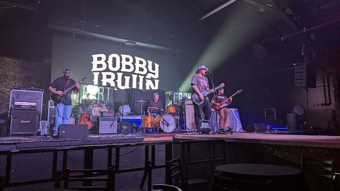 A group of people are playing instruments on a stage.