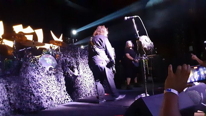 A band is playing on a stage in front of a crowd.