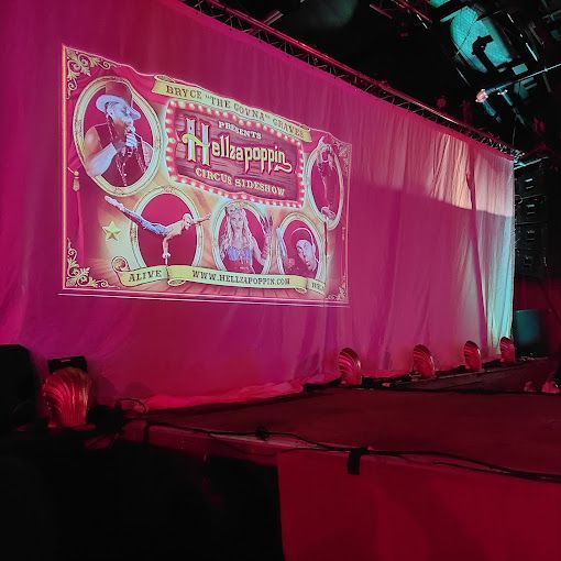 A large screen is projected on the wall of a stage.