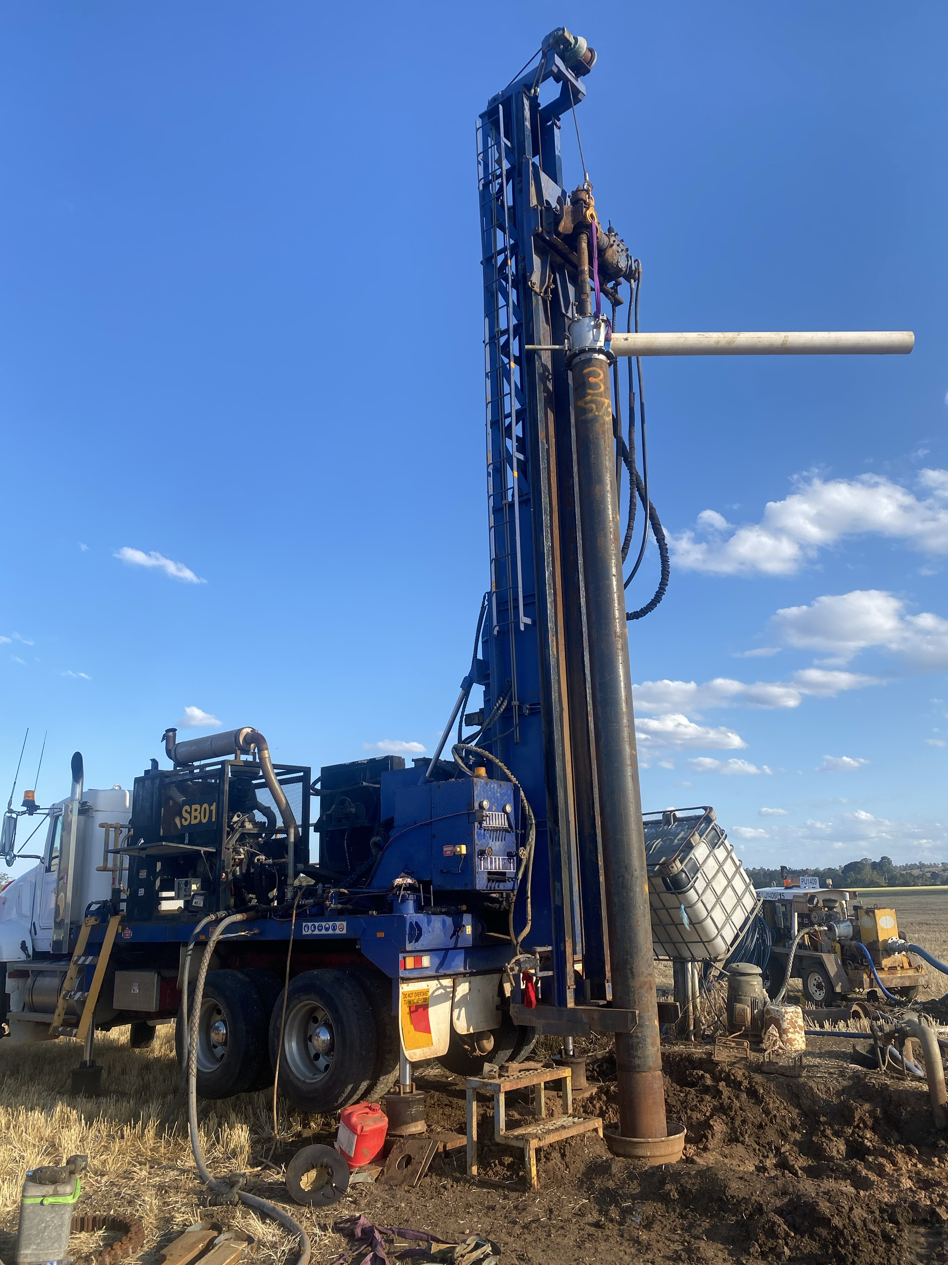 A man is working on a machine in a field.