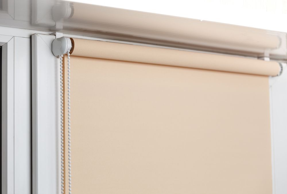 Blackout RollerBlind On The White Plastic Window — Window Coverings in Cardiff, NSW