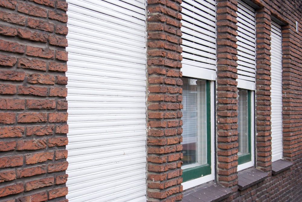 White Shutters For Four Windows — Window Coverings in Cardiff, NSW