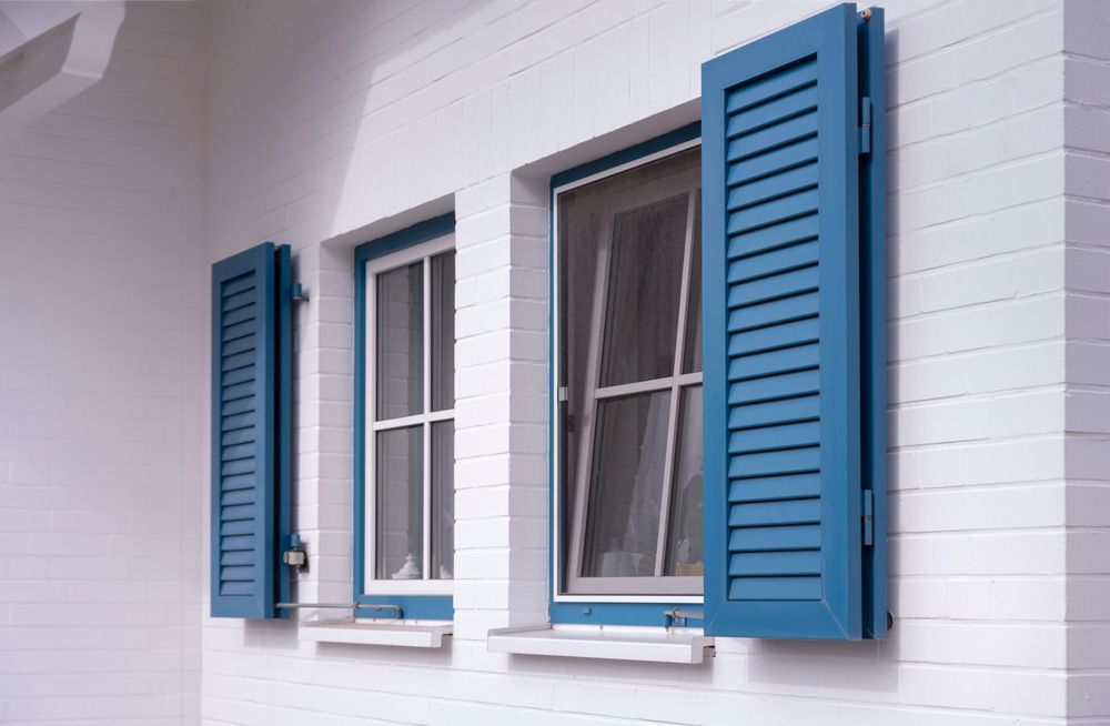 Two Blue Shutters With Windows — Wholesale Window Coverings in Newcastle, NSW