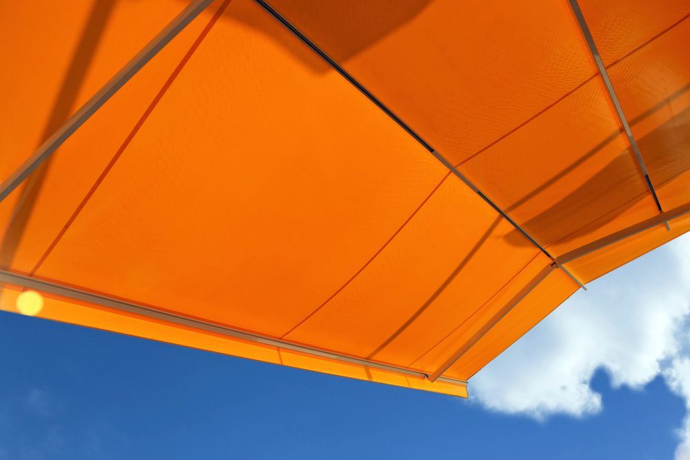 Orange Awning Against A Blue Sky — Wholesale Window Coverings in Maitland, NSW