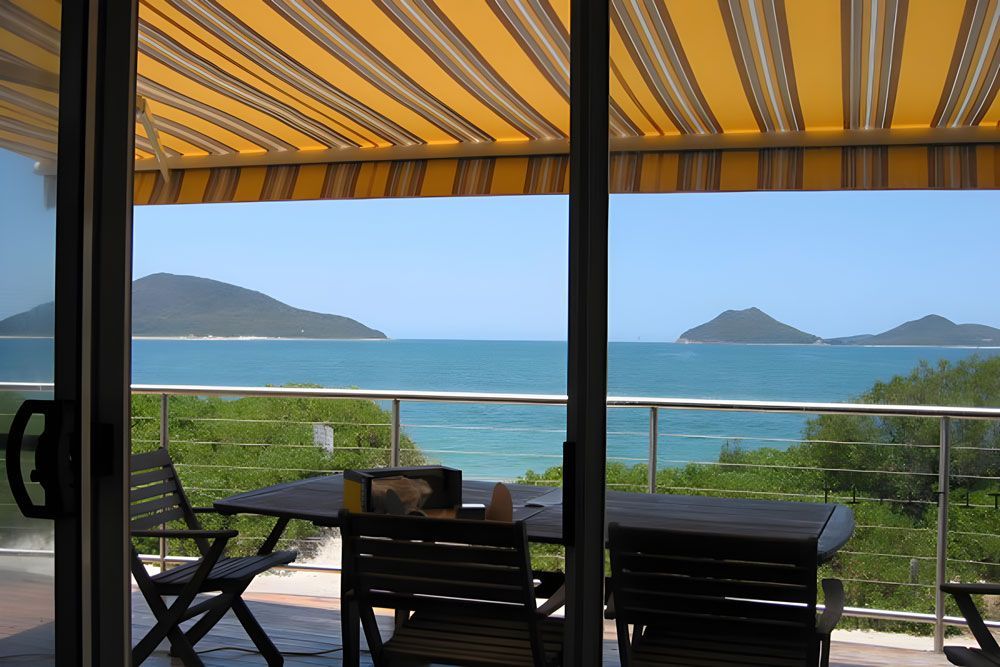 View Beach Beautiful And Yellow Awning Outdoor — Sturdy Window Awnings in Cardiff, NSW