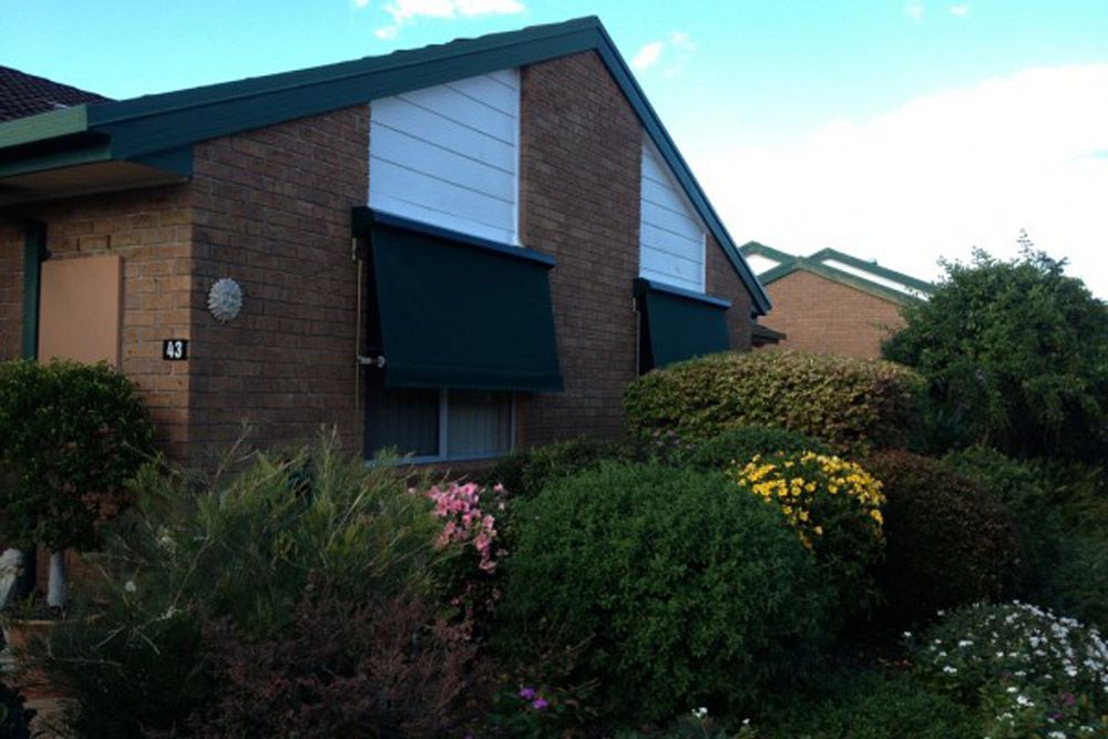 Side Left Two Awning And Home With Garden — Wholesale Window Coverings in Maitland, NSW