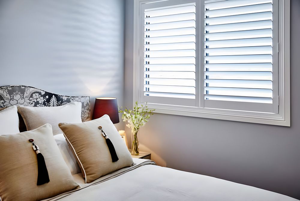 White Plantation Shutters In The Bedroom — Window Coverings in Cardiff, NSW