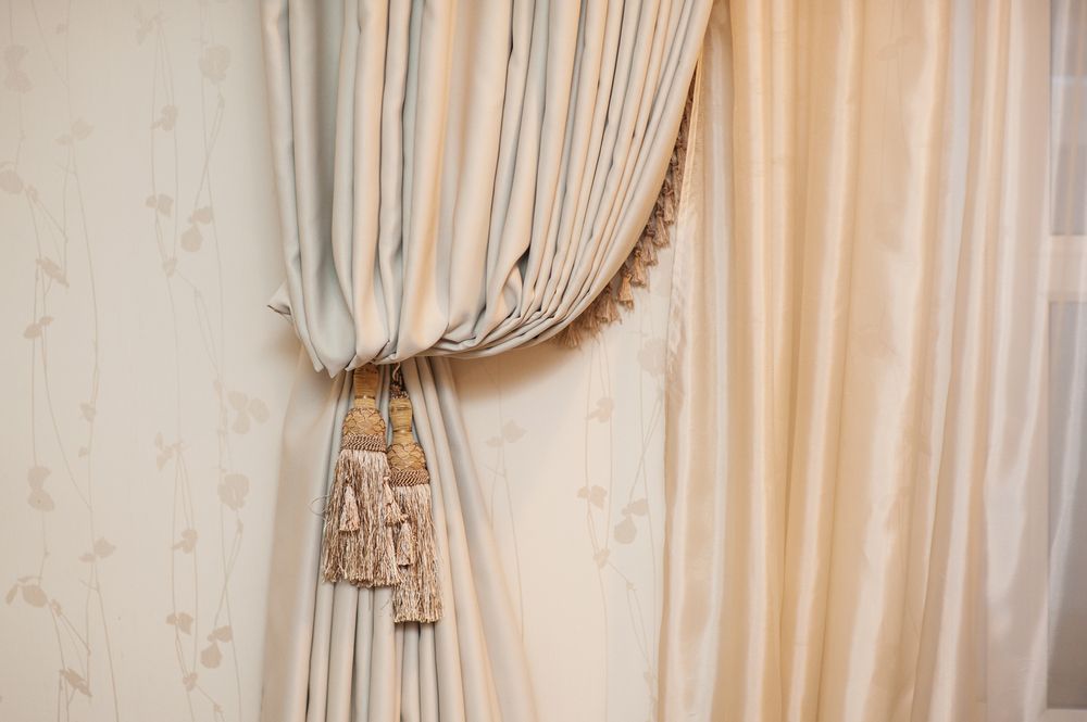 Beige Curtains, One Pulled Back With A Gold Tassel — Soft & Homely Curtains in Cardiff, NSW