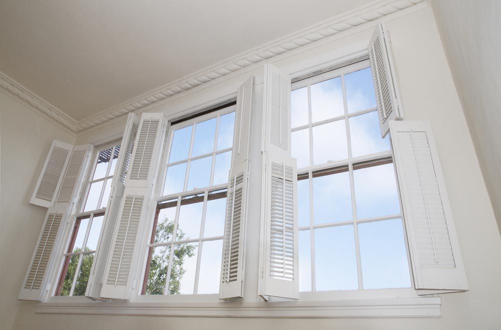 Room With Open Windows And Plantation Shutters