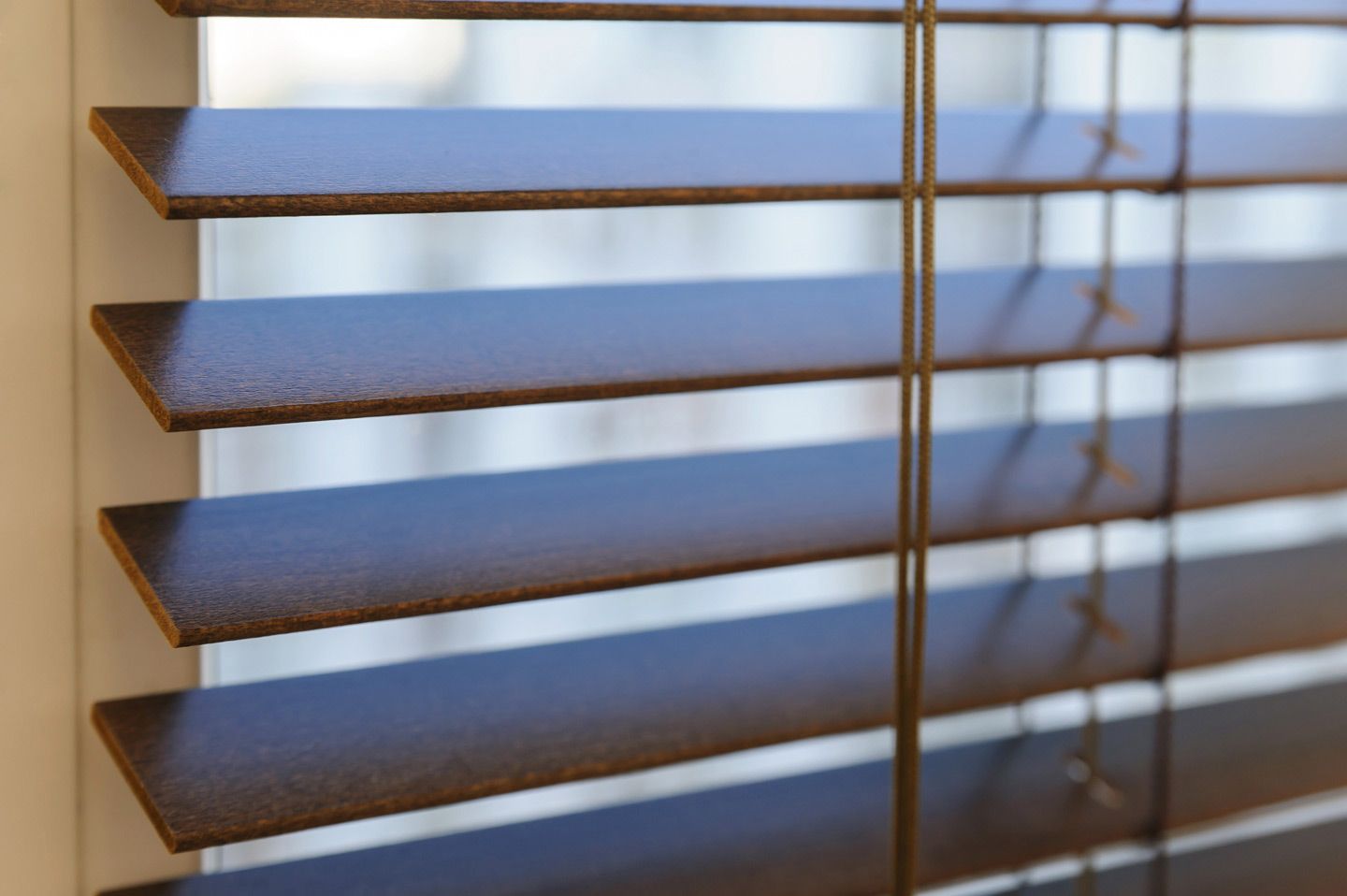 Wooden Shutters On The Window In The Living Room — Wholesale Window Coverings in Cardiff, NSW